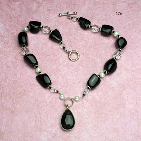 a classic piece with an element of cool: a black rutilated quartz faceted briolette bezel set pendant is paired with black rutilated quartz nuggets, pearls, rock quartz, and silver findings (#426)