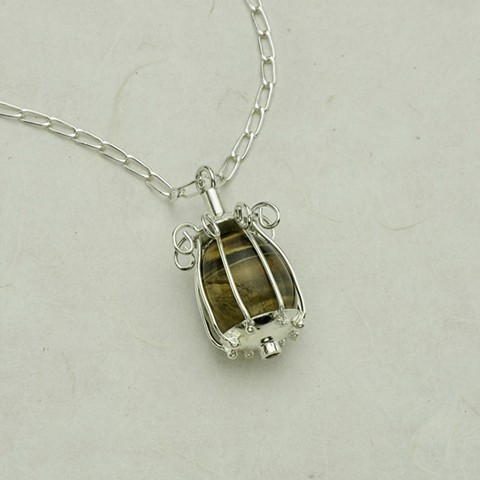 Tiger's eye egg in silver birdcage on 32" chain #899
