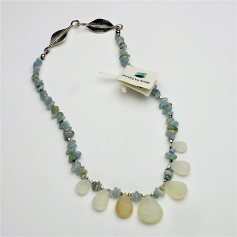 Sparkling moonstone briolettes are highlighted by tumbled aquamarine chips and tiny faceted silver beads. The 17" necklace is finished with a handcrafted double leaf clasp. (#824)