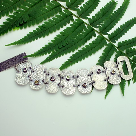 floral embossed silver link bracelet embellished with bezel set faceted amethyst, garnet, citrine and peridot gems (#137B)
