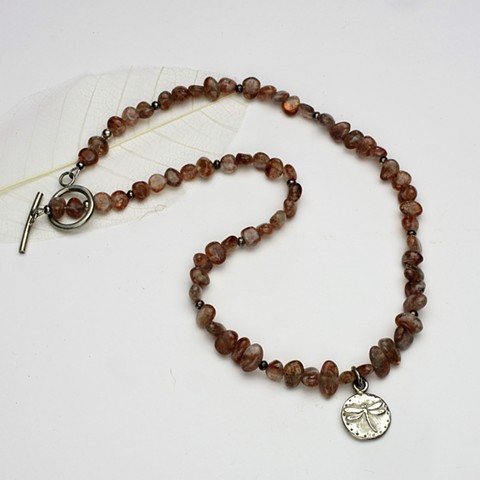 a sterling dragonfly pendant centers this 19' necklace of translucent sunstone tumbled nuggets & silver beads, finished with a sterling toggle. (#975)