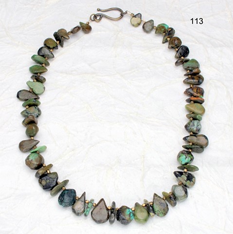unusually cut turquoise, forest hues, 
with brass findings (#113)