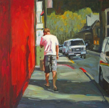 man walking by a bright red building