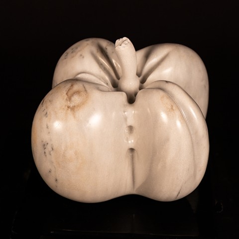 This is a marble sculpture representing a large “catfaced” tomato.