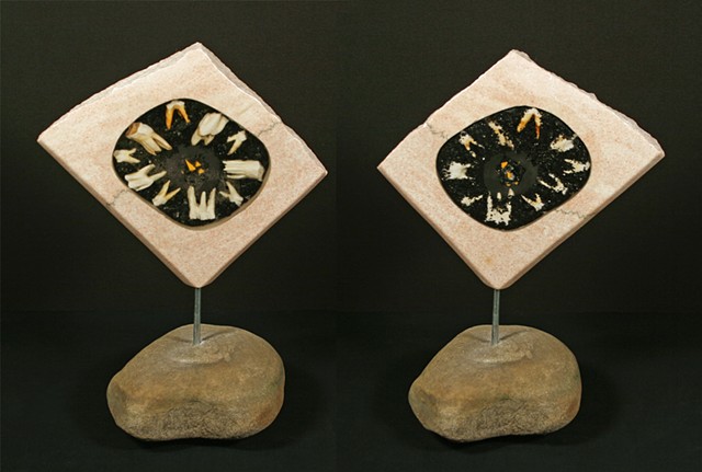This sculpture of the “geode series” consists of a pink open marble slab filled with coal, bovine teeth and glass shards encased in clear epoxy resin suspended by a metal pin on a natural sandstone base.
