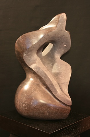 This is a modern contemporary stone sculpture; it consists of abstract plant forms and the human form by Denis A. Yanashot