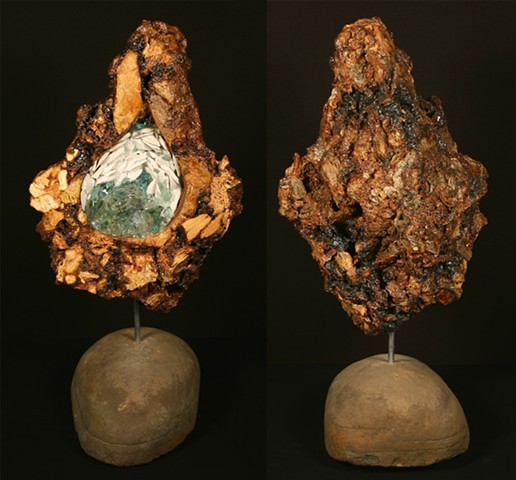 This piece is comprised of a carved anthracite burnt culm mass with adhered marble and Lackawanna River detritus glass in the geode-like cavity. Polyurethane was used to seal the burnt culm ash