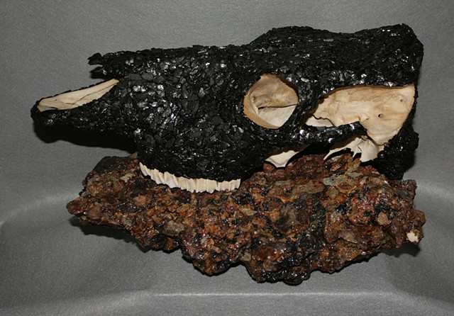 Coal Mosaic Sculpture resting on a combusted culm boulder from Scranton, PA by Denis A. Yanashot Sculpture.