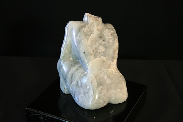 This is a modern contemporary stone sculpture of a seated nude done in green soapstone (steatite) by Denis A. Yanashot