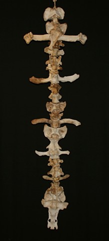 This is a modern contemporary mixed media sculpture of bone with the effect of stacked crucifixes by Denis A. Yanashot