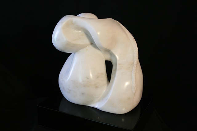 This is a modern contemporary stone sculpture of two masses of biomorphic forms interacting (embracing) by Denis A. Yanashot