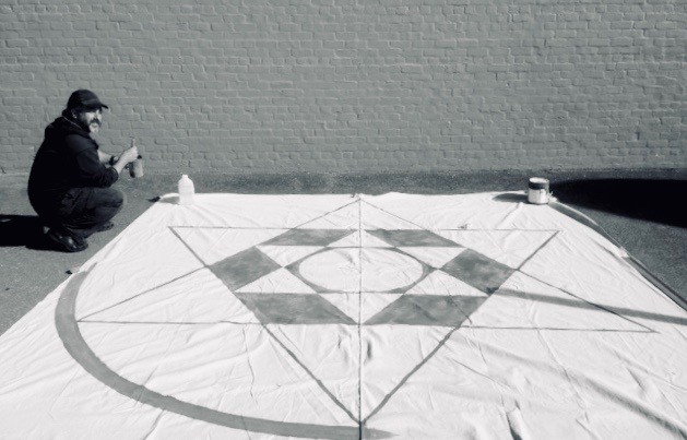 painting a floor painting of the Star of David for Esalen Workshops