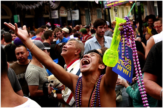 An attendee of Southern Decadence yells at other attendees on a bourbon street balcony in hopes of getting beads. Tropical Storm Lee caused the cancellation of numerous events for Labor Day weekend through out New Orleans and Louisiana. Despite the rain t
