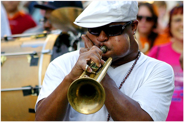 A member of Rebirth Brass Band  plays on his trumpet while the band leads a second line through New Orleans on the 6th Anniversary of Katrina, ending with the unveiling of a memorial at the Sartatoga Building.