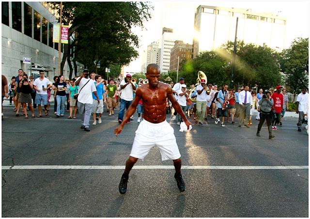 Darryl Young A.K.A. “Dancing Man” dances in the street during the Katrina second line and memorial unveiling.