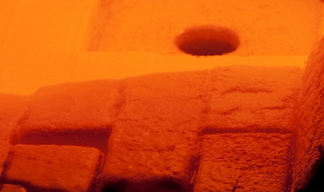 Enlarged closeup of the hot interior space of a glass melting furnace.