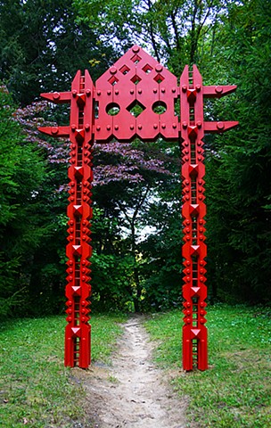 Portal mediates the junction between a formal path and the wild woods beyond.