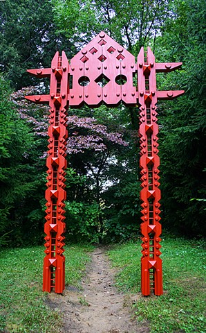 Portal mediates the junction between a formal path and the wild woods beyond.