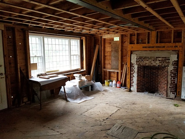 Living Room With Center Wall Removed + New Fireplace Under Construction