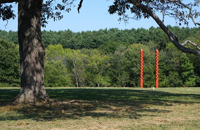 External Link - a pair of carved rhythmic obelisks frame views, imply an axis, and become a gate 
