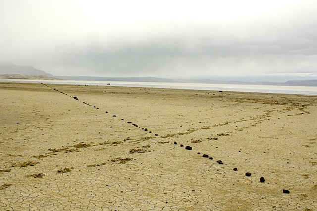 1500 foot line of stones set in the mud flat of Summer Lake, Or., orientated to the north star.  2012. Archival ink jet print, 20x13"