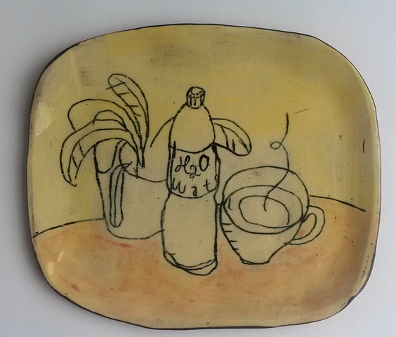 studio plate with plant, cup and bottle