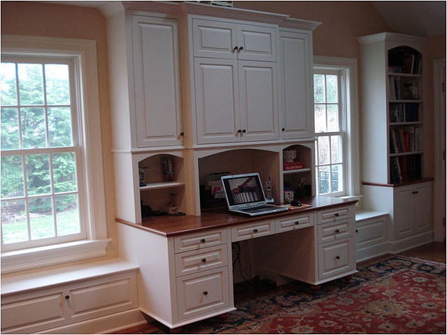 Built-in desk, bookcases, cabinet and window seats.