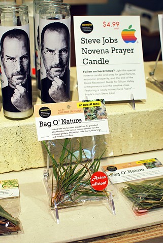 Steve Jobs Novena Candles and Bag O' Nature
2012
Modified candles and an arrangement of botanical materials in packaging