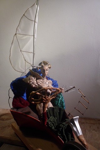 Ceramics and Mixed Media Sculpture of a woman in a winged, wheeled, red boat 