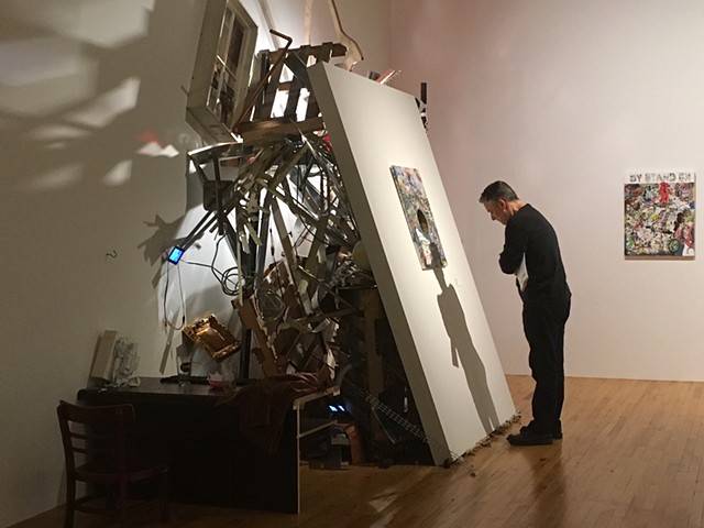 "Sitting Down For a Drink With My Shadow" is a mixed-media installation sculpture created for the "Suffering From Realness" exhibition at Mass MoCA. April 2019 through 2020. Materials include Projection Light, Cast Shadow, Steel, Blinds, Trolls, Lead, etc