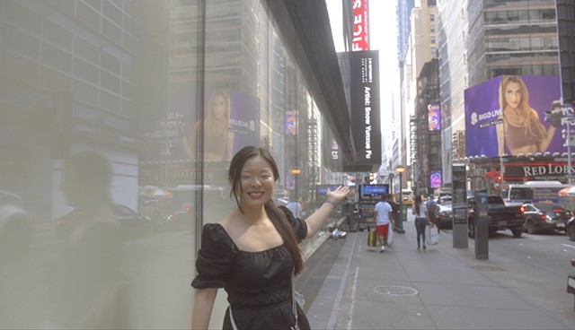Artist Snow with her work on ZAZ Billboards at Times Square