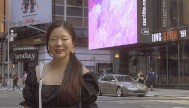 Artist Snow with her work on ZAZ Billboards at Times Square