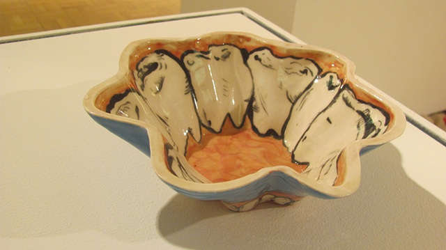 Cereal bowl with teeth lining the inside, the foot, and the underside of the bowl 