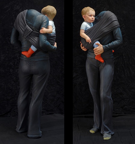 Life-size figurative sculpture of a headless woman holding a small child in a sling