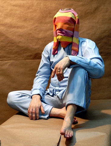cast ultracal figurative polychrome sculpture of a man with a small child's shirt over his head