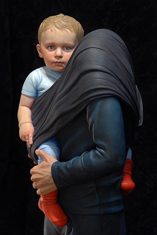 Life-size figurative sculpture of a headless woman holding a small child in a sling