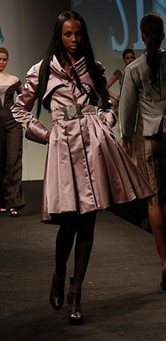 photo of model wearing double-faced silk satin pleated coat designed by sarah buck mueller