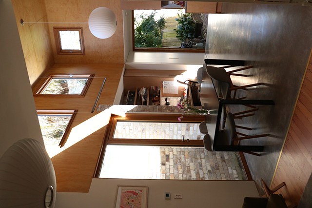 admitting light and allowing it to bounce around using reflective surfaces such a poliched conctere and varniched plywood