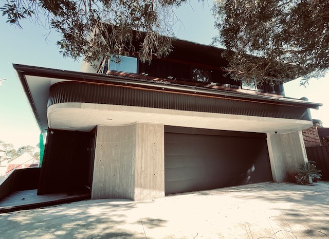 off form slatted concrete wall with a corro roof