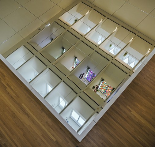 Installation view of mirrored floor reflecting "rooms"