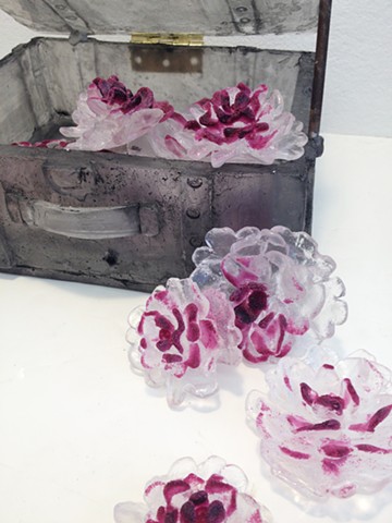 Cast glass flowers (peonies) and a suitcase. Glass narrative.