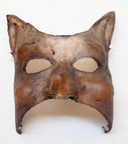 Cast glass masks depicting a cat and a mouse. Glass narrative. Storytelling.  Surrealism.