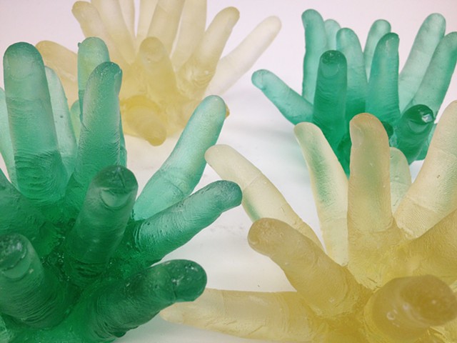 Cast glass fingers inspired by dreams and anxiety, and sea anemone