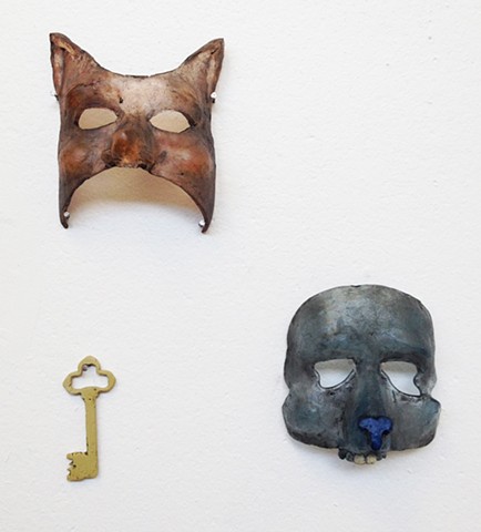 Cast glass masks depicting a cat and a mouse,Glass narrative. Storytelling.  Surrealism.