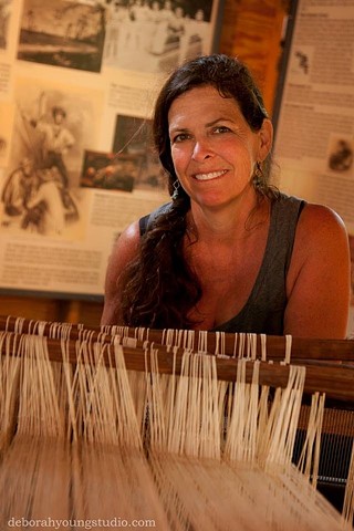 Beth at one of her barn looms displayed at Island Farm. 