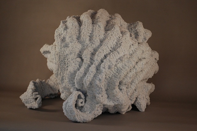 Chenille stem sculpture in the shape of a shell, inspired by the marble fountains of Rome.