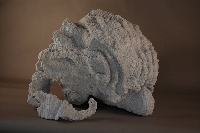 Chenille stem sculpture in the shape of a shell, inspired by the marble fountains of Rome.