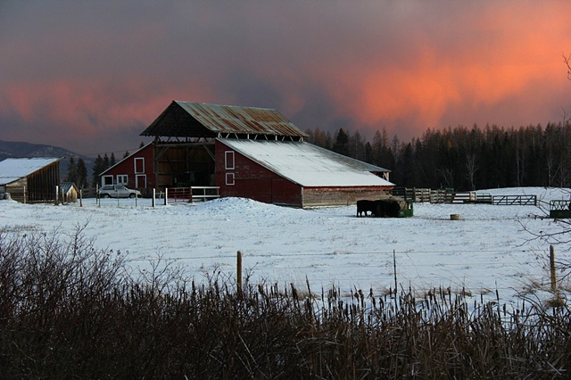 A mid-November sunset illuminates a farm near the Swan River in Montana.