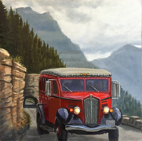 A classic "red jammer" echoes the past on a cool, misty day in Glacier National Park, Montana.