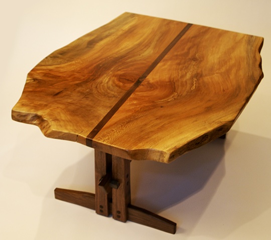 This table features a free edge sycamore top with striking grain pattern, and a contemporary black walnut base.